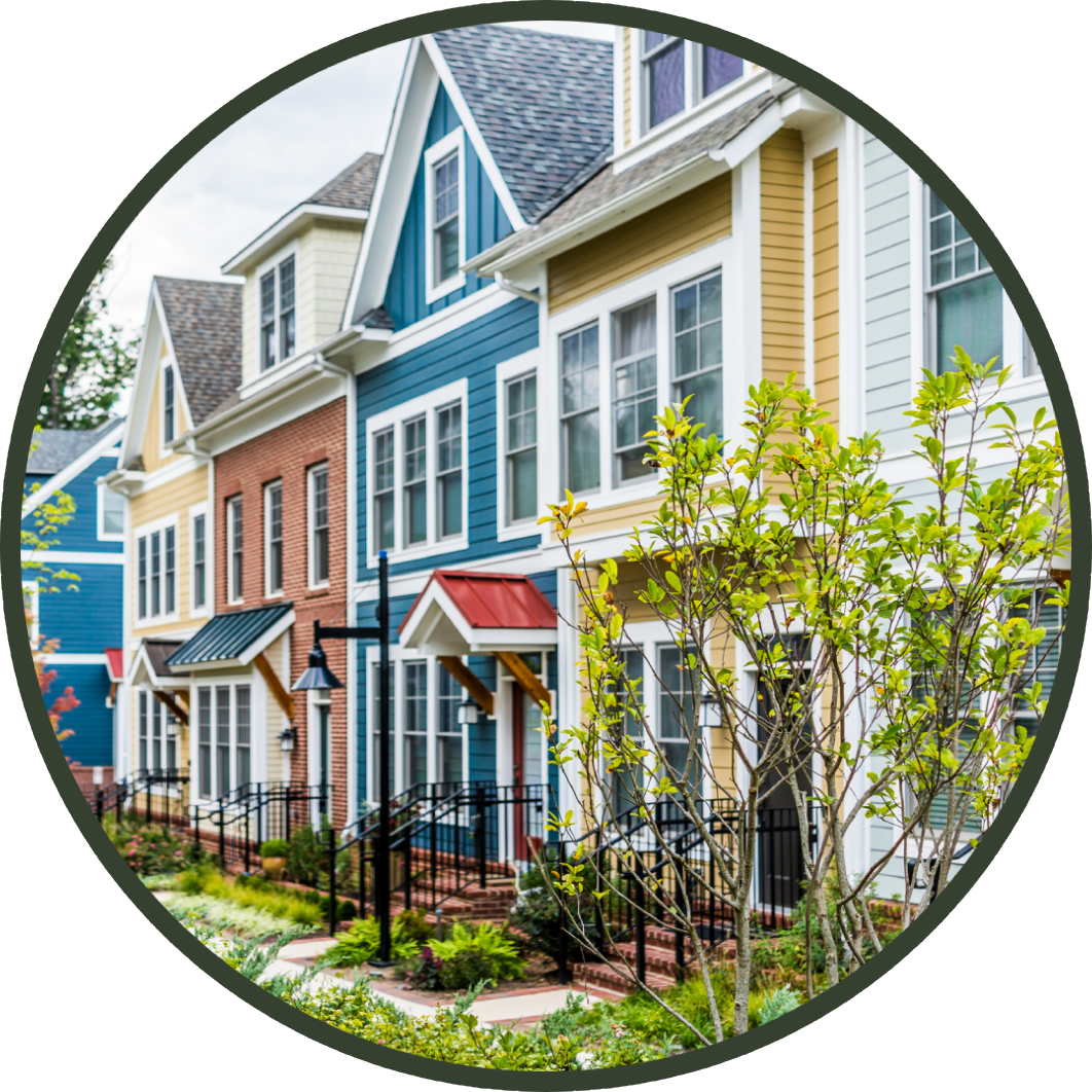 A picture of some houses with trees in the background.